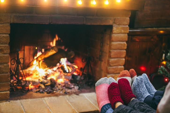 socks in front of a lit fireplace