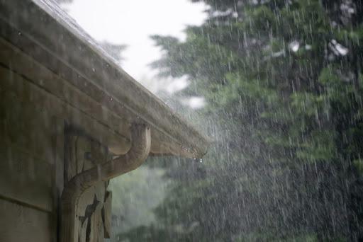 rain outdoors on a home's gutter