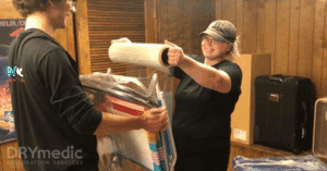 a person holding a roll of plastic